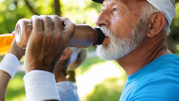 image of elderly man drinking milk protein drink