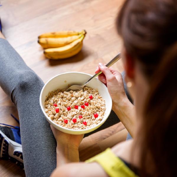 image of a woman eating oats