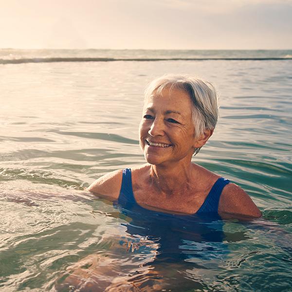 image of an older woman in the sea swimming