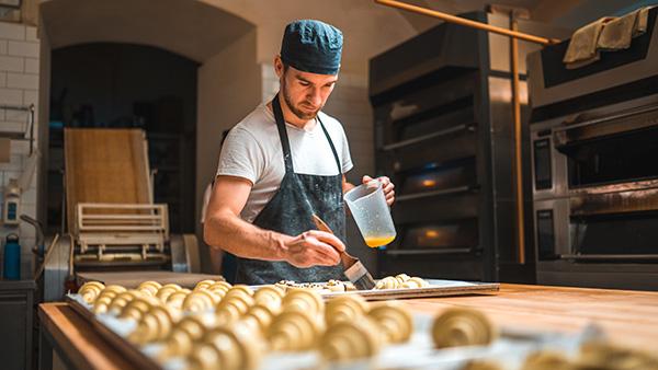 baker adding water to pastries