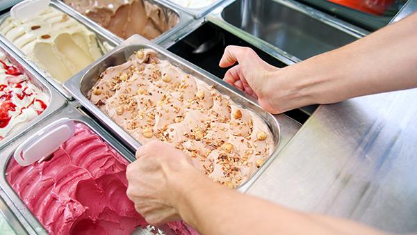 man taking out large tray of ice cream