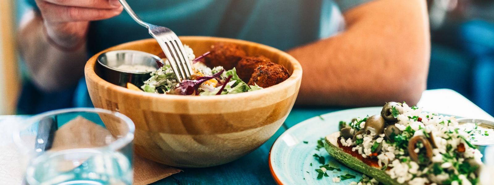 Man eating a vegan salad